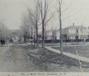 Standing on Main Street in front of church parsonage looking north. The horse and buggy is actually in the intersection of East and West Shore Road.