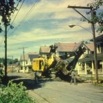 Pulling a tree stump out in front of the Meyers home on North Main Street. You can see the H.S in the background. 23
