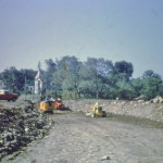 Looking south, North of the Village, the new road is taking shape. Grenier's house has been moved back and you see it on the right. 32