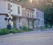 Looking north over the RR tracks, from front to rear, the Shoudy House, Dobert’s Store and Former Central House Hotel. M-21