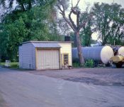 Looking south on Main at Edward's Oil Company currently where the gazebo is located. The creek was just behind the oil tanks. M-24