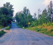 On Fairview Ave (currently Alexander Rd.), looking west, road behind school .omes in on left. M-9