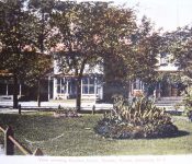Photo was taken from what is now the Village Parking lot looking west at the Central House and Gardner Grocery Store from the train station garden